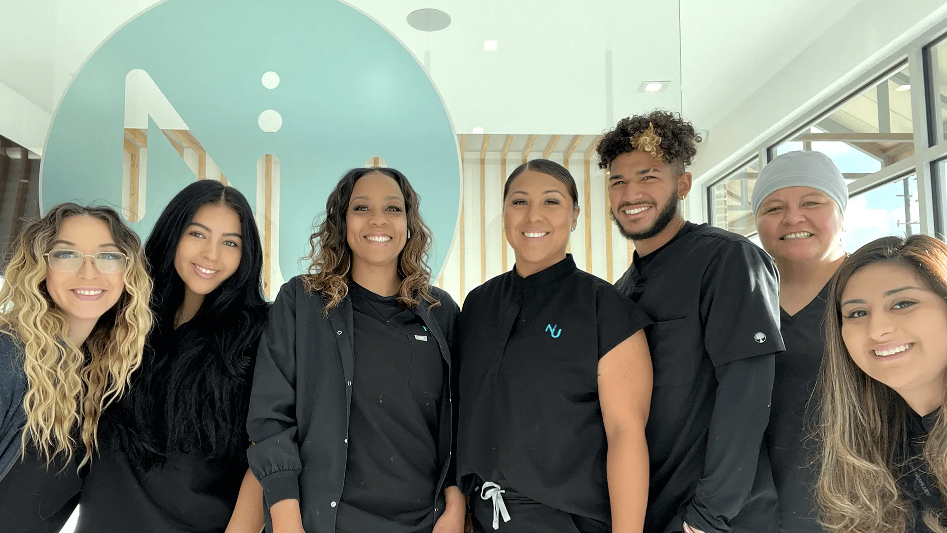 Nu Dentistry Spring dental team smiling in black scrubs